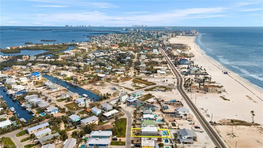 Virtually Enhanced Aerial view featuring a view of the beach and a water view