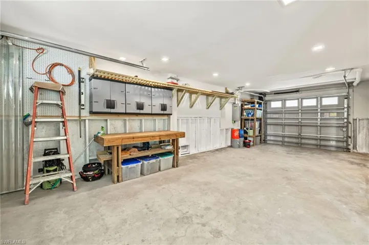 Garage featuring recessed lighting and electric panel