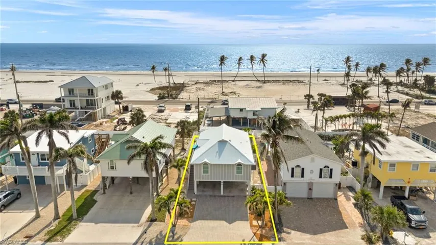 Virtually Enhanced Birds eye view of property with a water view, a residential view, and a view of the beach