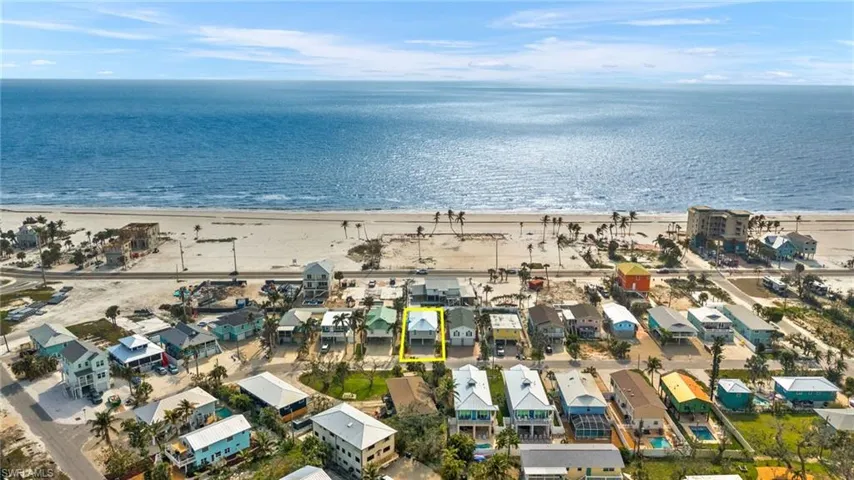 Drone / aerial view featuring a beach view and a water view