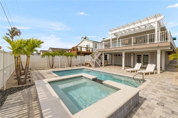 View of swimming pool featuring a patio area, a fenced backyard, and french doors
