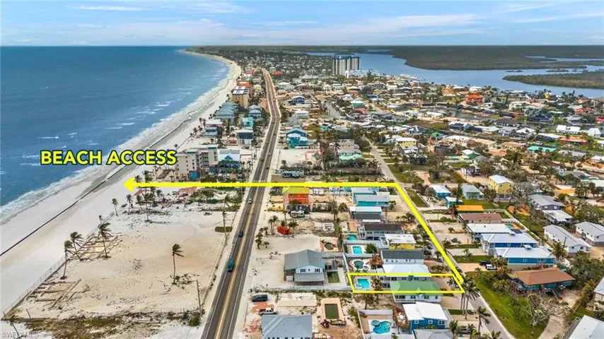 Birds eye view of property with a view of the beach and a water view - Virtually Edited Image