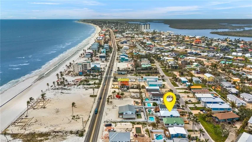 Drone / aerial view featuring a beach view and a water view - Virtually Edited Image