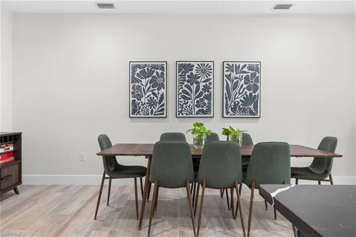 Bright interior space featuring light-toned walls, recessed lighting, and wood-finish flooring