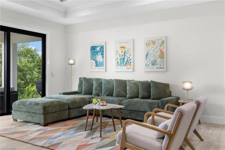 Living area with light wood-finish flooring and white walls