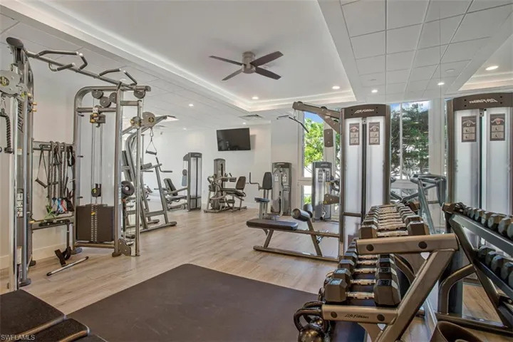 Gym with recessed lighting, ceiling fan, and expansive windows