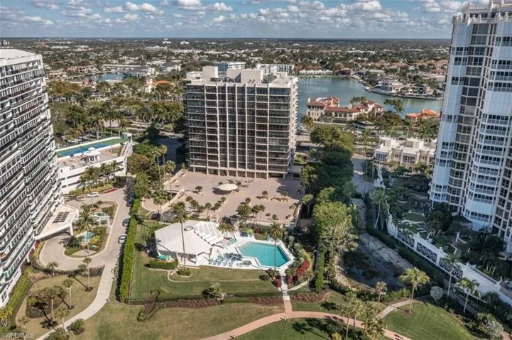 View of urban area with a pool area and a large body of water