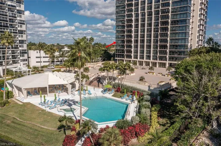 Community pool with a patio area, a lawn, and a jacuzzi