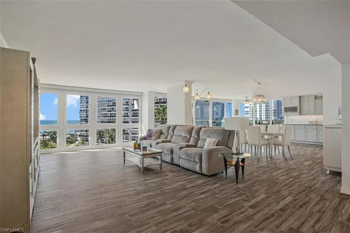 Living room featuring a chandelier and dark wood-type flooring