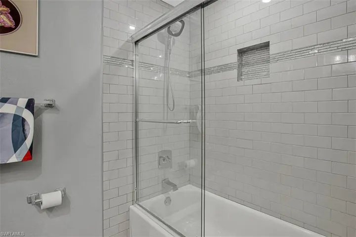 Full bath with shower / bath combination with glass door