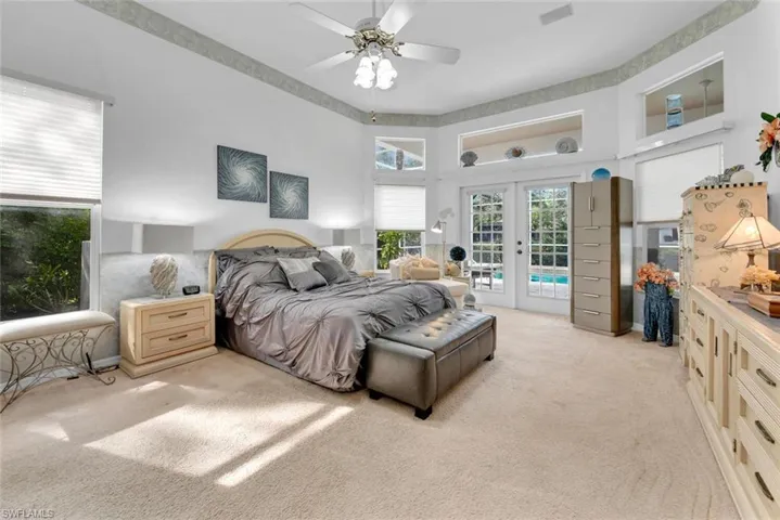 Large primary bedroom with french doors to the lanai