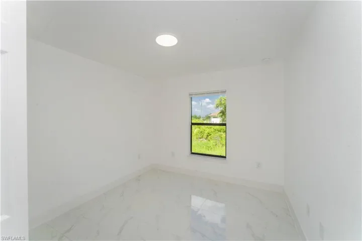 Empty room with baseboards and light marble finish floors