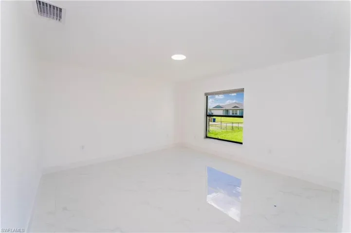 Unfurnished room with light marble finish flooring and recessed lighting