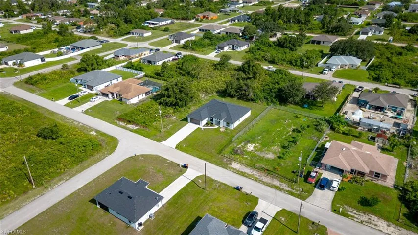 Aerial view of property and surrounding area with nearby suburban area