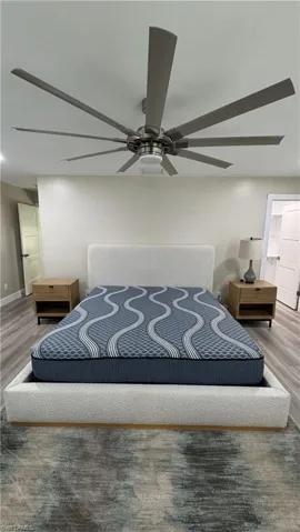 Bedroom featuring wood finished floors and a ceiling fan