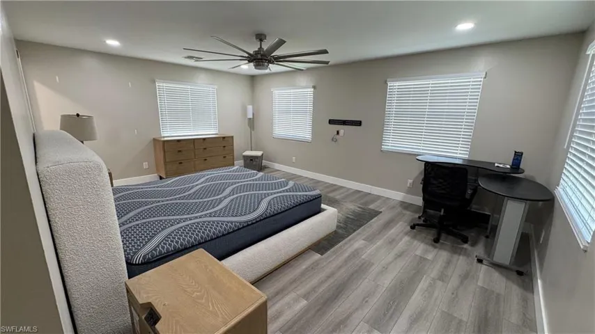 Bedroom with wood finished floors, recessed lighting, baseboards, and a ceiling fan