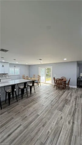Dining space with light wood-type flooring, plenty of natural light, recessed lighting, and baseboards