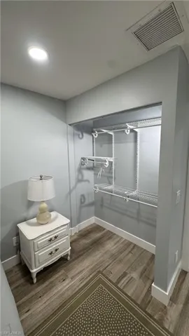 Bathroom with wood finished floors and baseboards