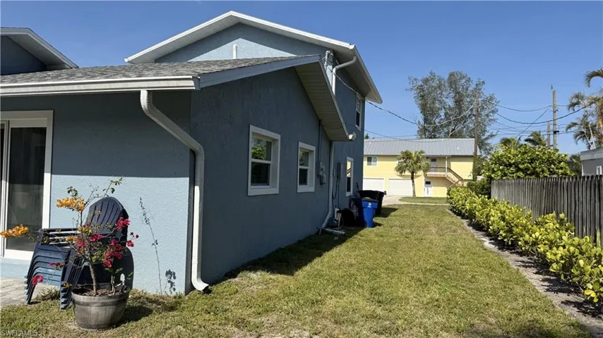 View of side of home featuring stucco siding