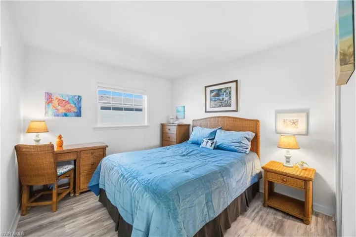 Bedroom with light wood finished floors and baseboards