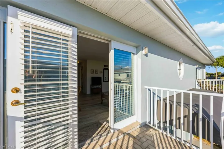 Balcony to property with stucco siding