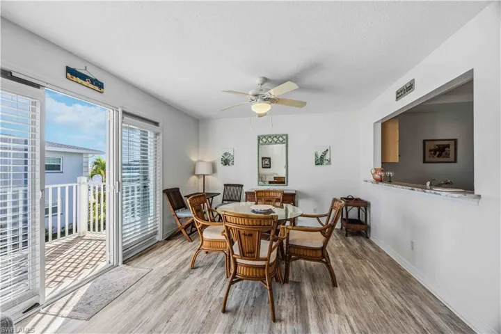 Dining area with ceiling fan, wood finished floors, and a textured ceiling