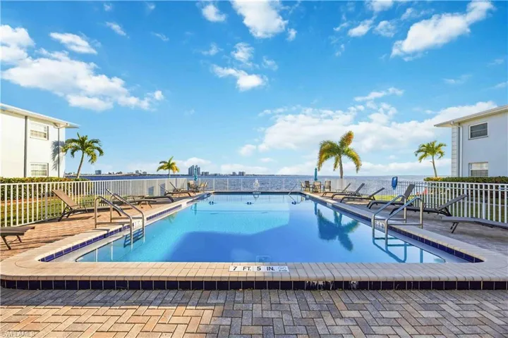 Community pool with a patio