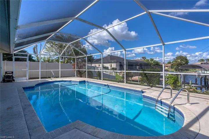 View of pool featuring a patio area and a lanai