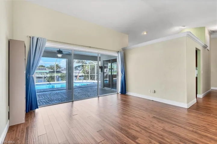 Empty room with wood-type flooring and ceiling fan