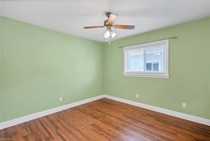 Spare room featuring hardwood / wood-style flooring and ceiling fan