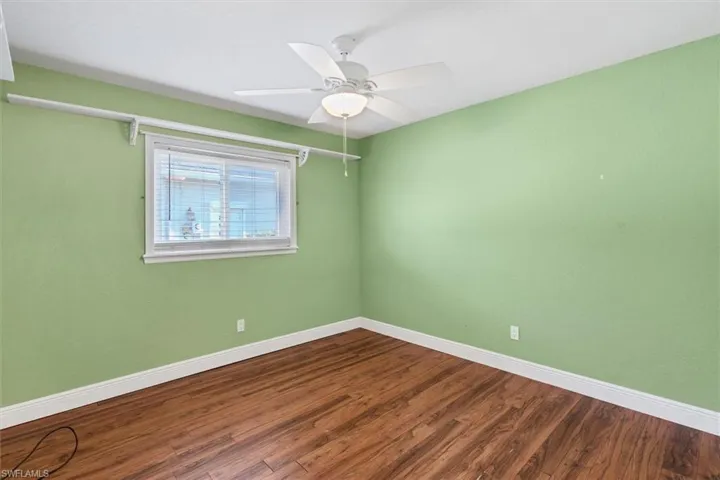Spare room with hardwood / wood-style flooring and ceiling fan