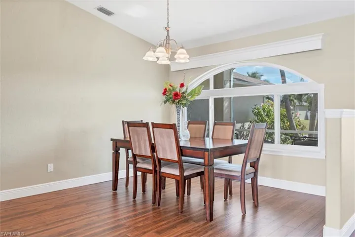 Dining area featuring a chandelier and dark hardwood / wood-style floors