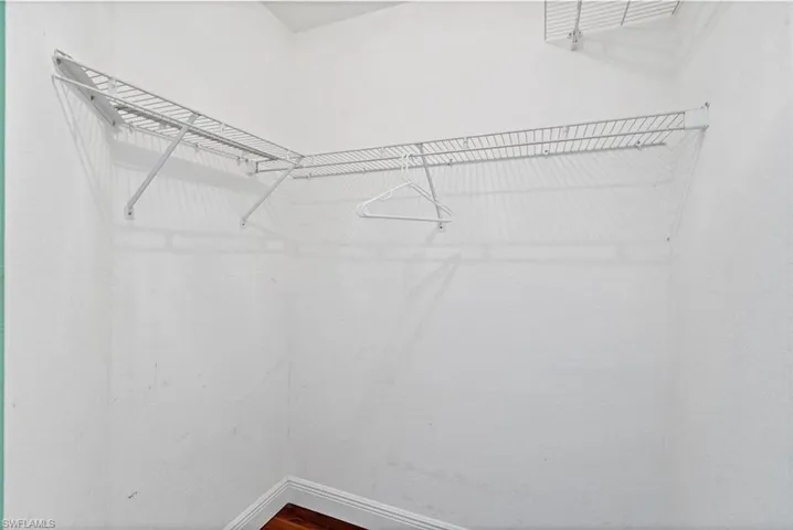 Walk in closet featuring hardwood / wood-style flooring