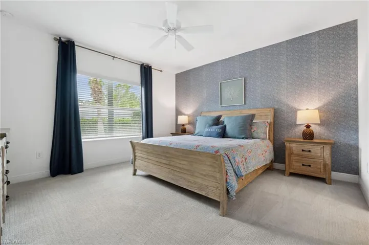 Bedroom with light carpet and ceiling fan