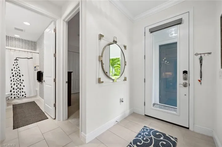 Tiled entrance foyer with ornamental molding