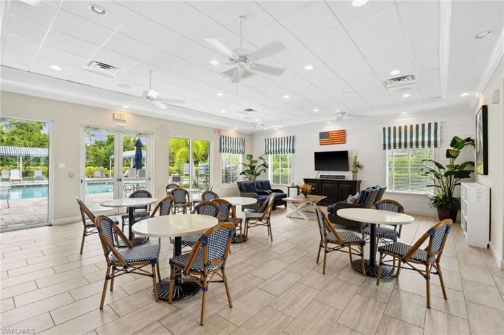 Dining space with a drop ceiling, ceiling fan, french doors, and crown molding