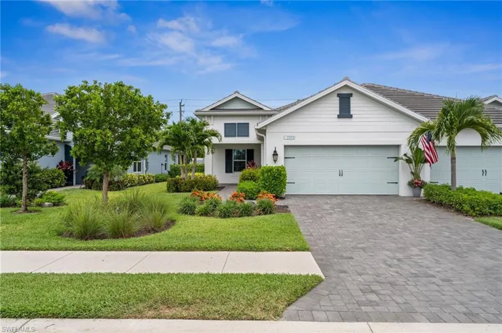 View of front of house featuring a garage and a front yard