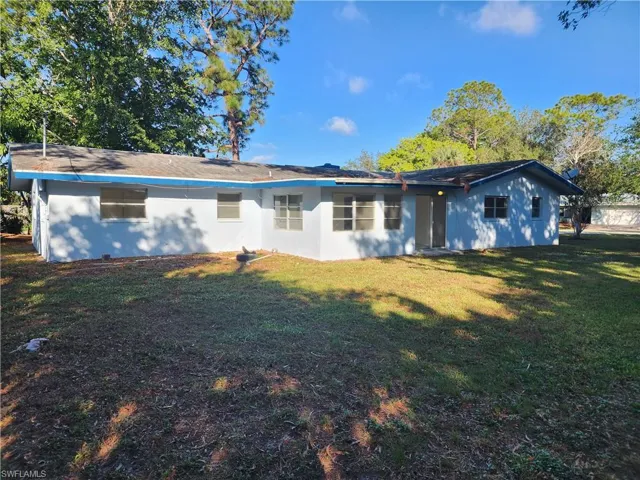 Rear view of property featuring a yard