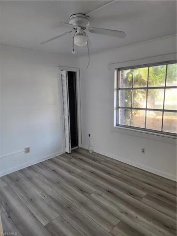 Empty room featuring ceiling fan and hardwood / wood-style flooring