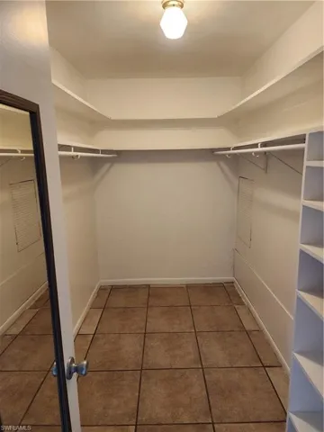 Spacious closet with dark tile patterned flooring