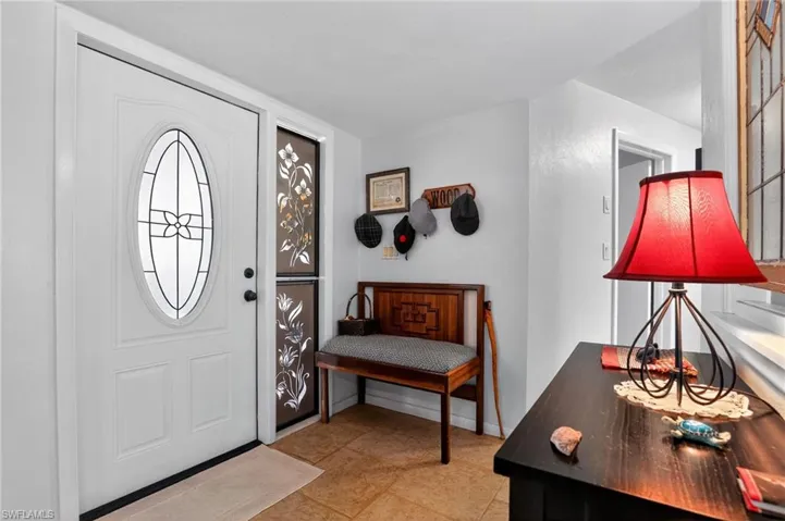 Entrance foyer with light tile patterned floors and baseboards