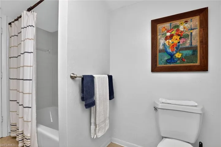 Bathroom featuring shower / tub combo and toilet