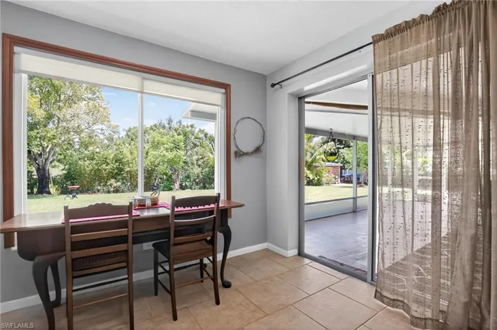 Dining area featuring baseboards and light tile patterned floors