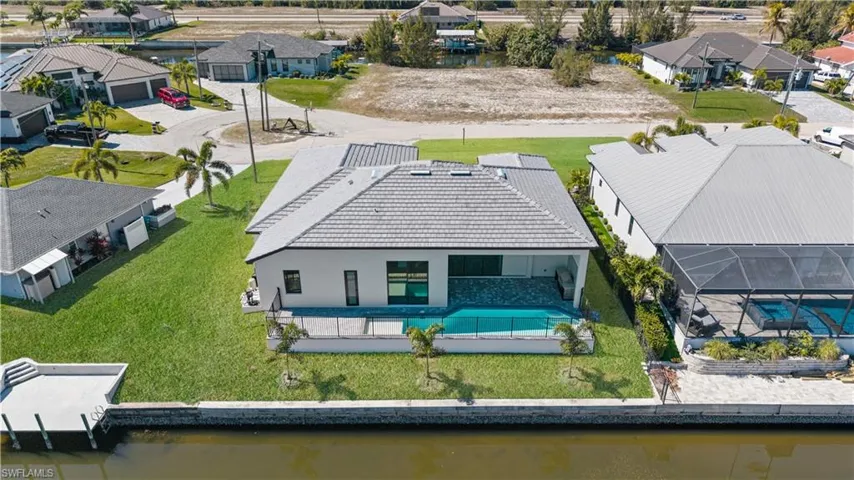 Aerial perspective of suburban area featuring a large body of water