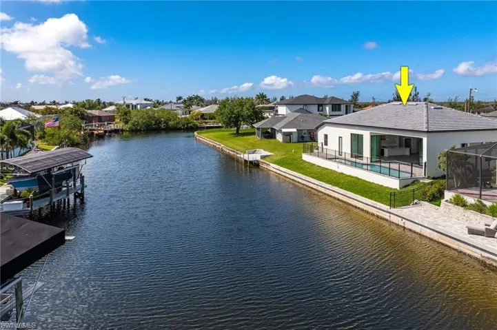 Water view with a boat dock and nearby suburban area