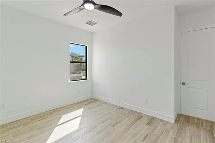 Spare room with wood tiled floors and ceiling fan