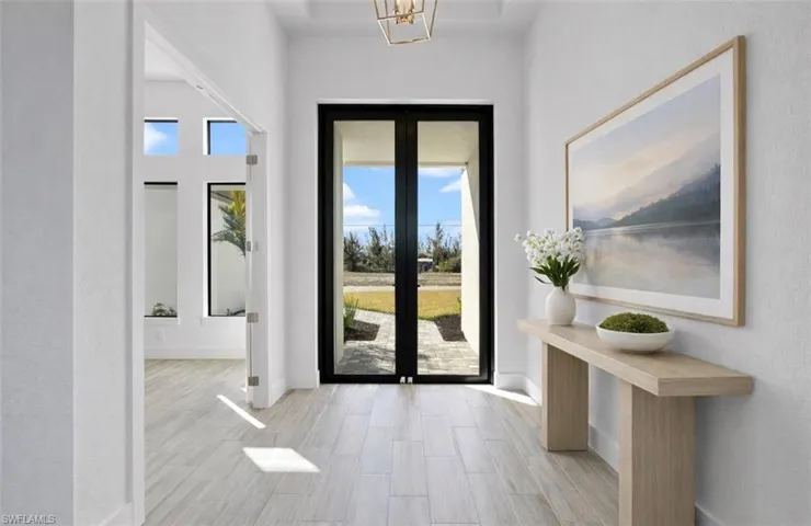 Entrance foyer featuring wood finish floors and a textured wall