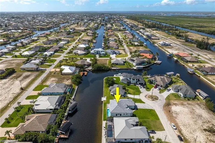 Aerial view of property's location featuring nearby suburban area and a large body of water