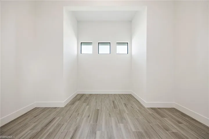 Empty room featuring wood finish floors and baseboards