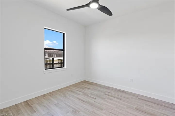 Empty room featuring wood finish floors and ceiling fan